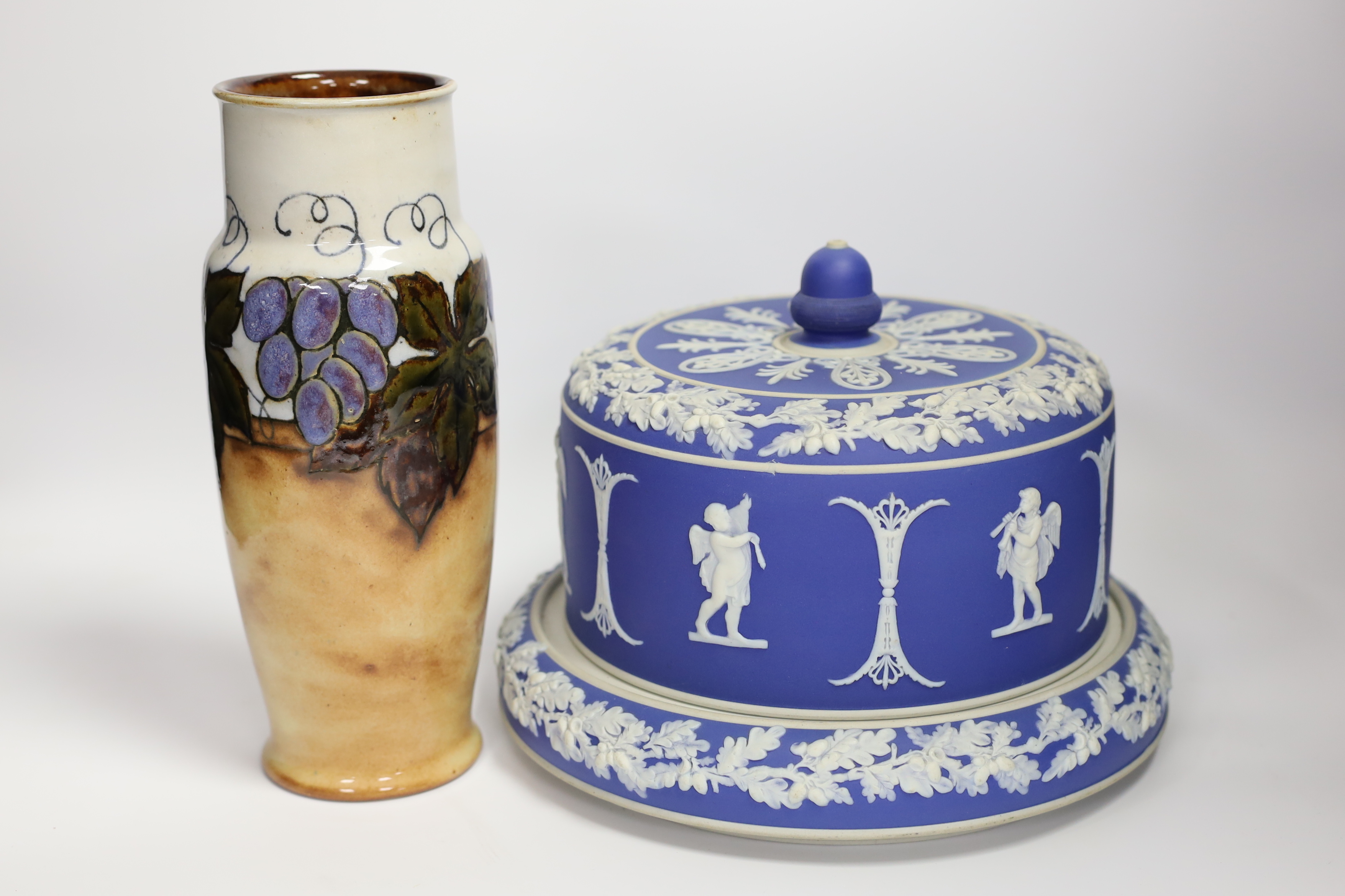 A Victorian blue Jasperware cheese dome with a on knop and Royal Doulton grapevine vase, largest 26cm high